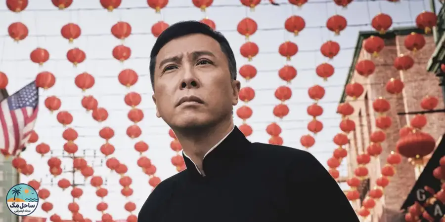 Donnie Yen standing under several rows of Chinese lanterns in Ip Man 4