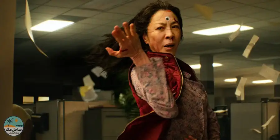 Evelyn Wang with a googly eye on her forehead strikes a pose as paper whirl around her
