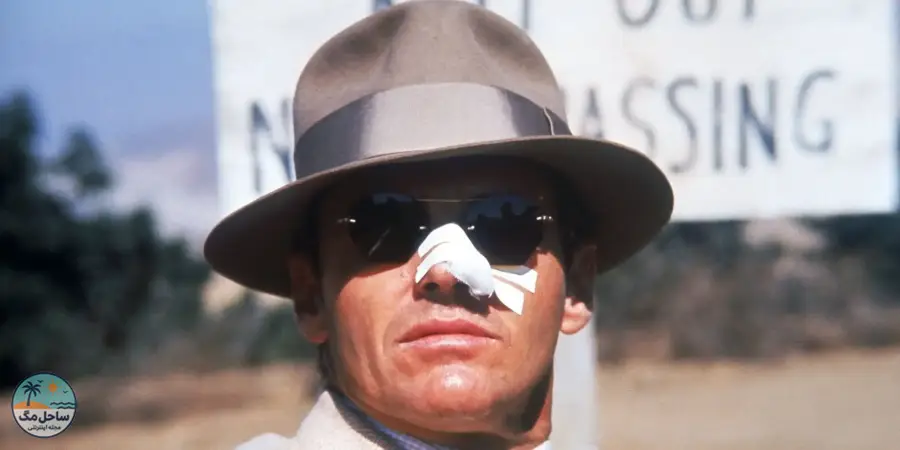 Jack Nicholson as Jake Gittes with a broken nose looking ahead in Chinatown. 